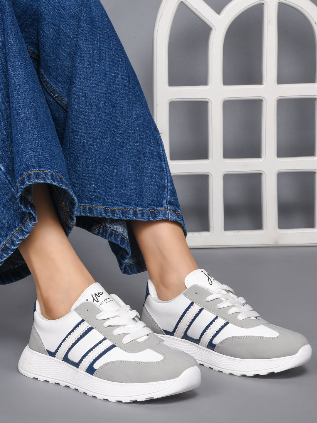 Women's lace-up casual sneakers in grey white with blue stripe detailing on cushioned white platform sole