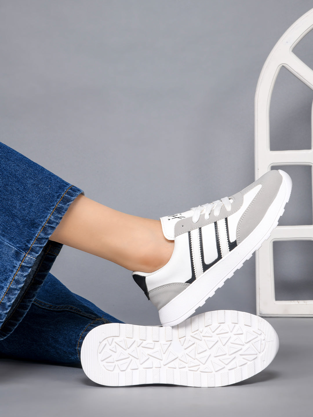 Women's lace-up casual sneakers in grey white with black stripe detailing on cushioned white platform sole