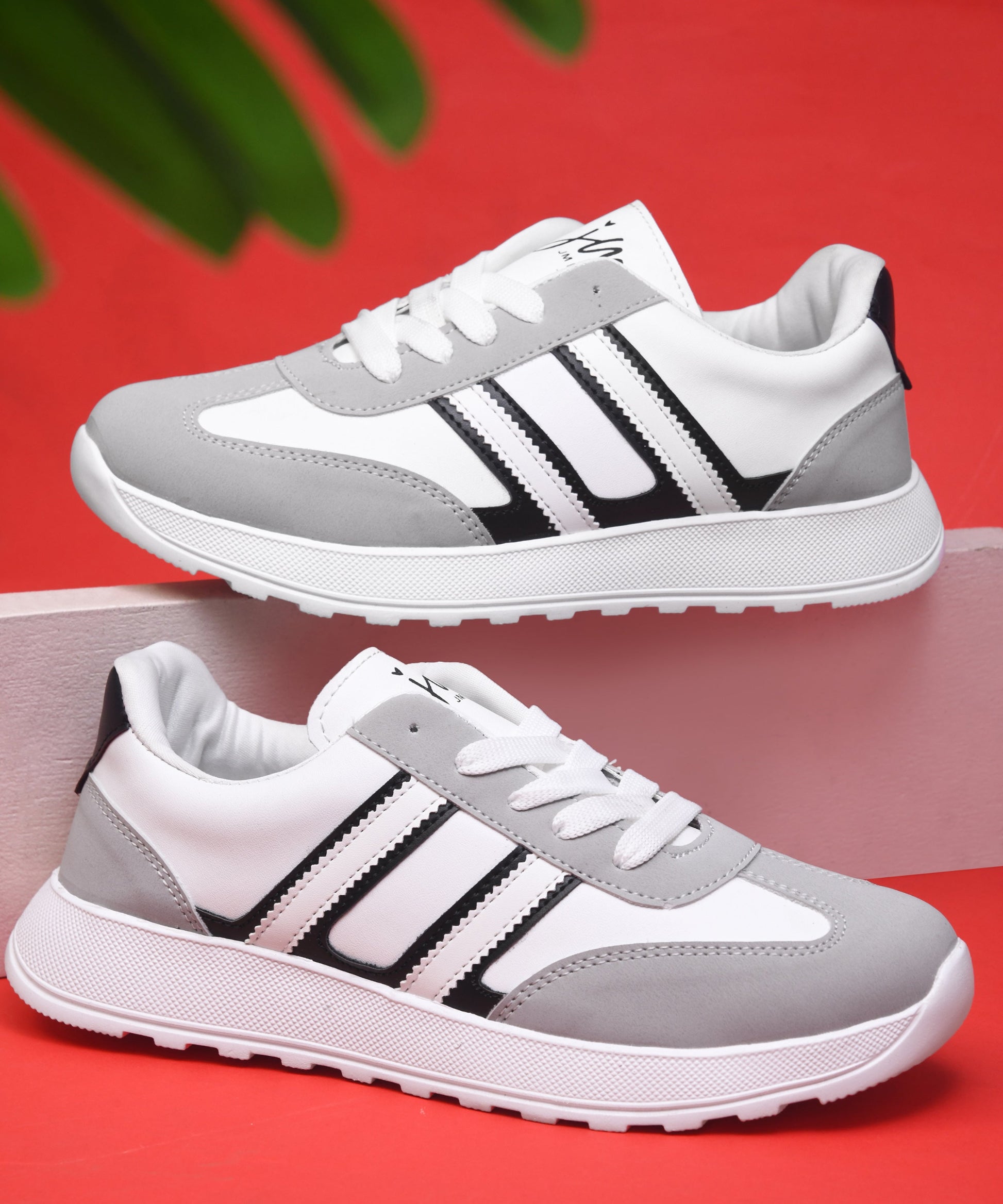 Women's lace-up casual sneakers in grey white with black stripe detailing on cushioned white platform sole