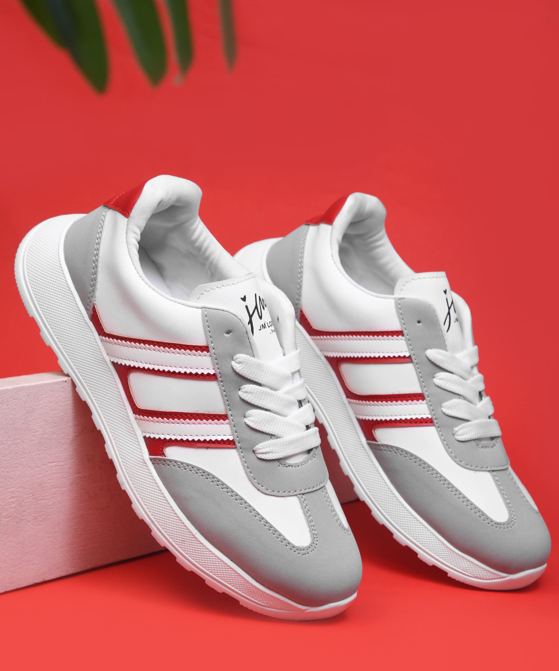 Women's lace-up casual sneakers in grey white with red stripe detailing on cushioned white platform sole