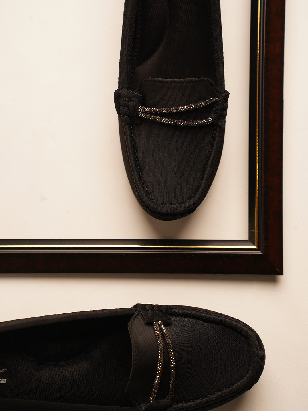 loafers with a subtle wedge heel and an embellished buckle detail on the vamp
 Black