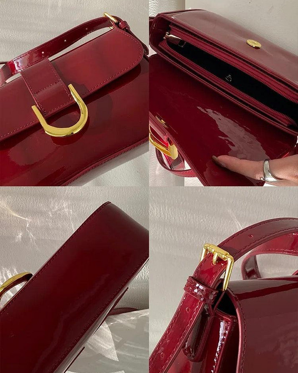 Red crossbody shoulder bag with gold U-shaped buckle, adjustable strap, and glossy leather finish for women