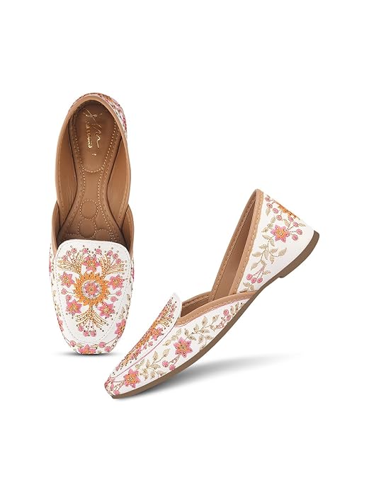 White embroidered juttis with intricate threadwork — women's traditional mojari flats