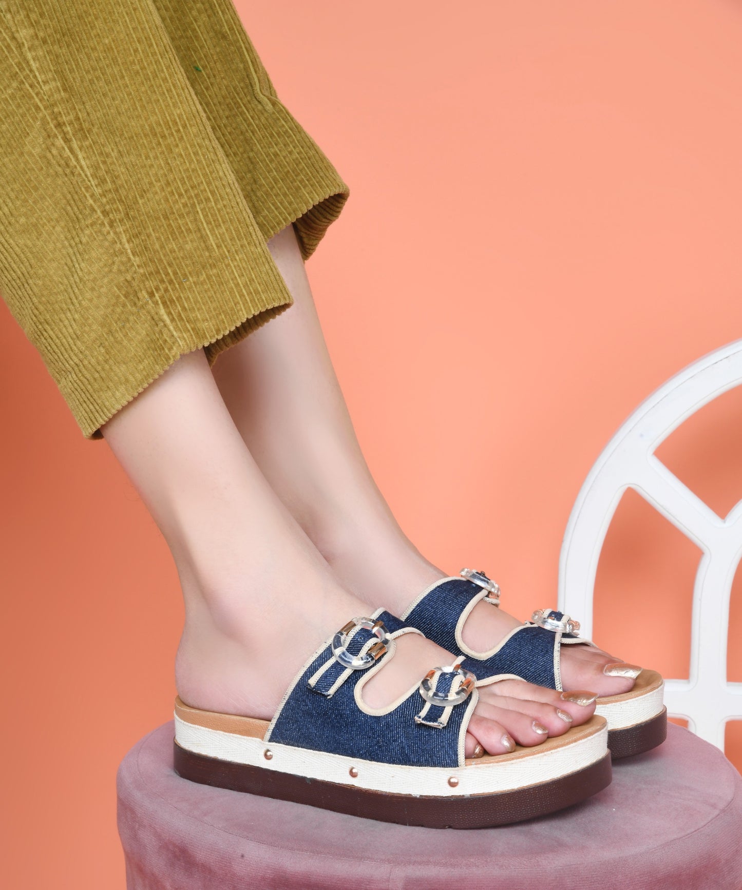 Navy denim platform slides for women with dual straps, clear buckles, cushioned tan footbed and chunky sole