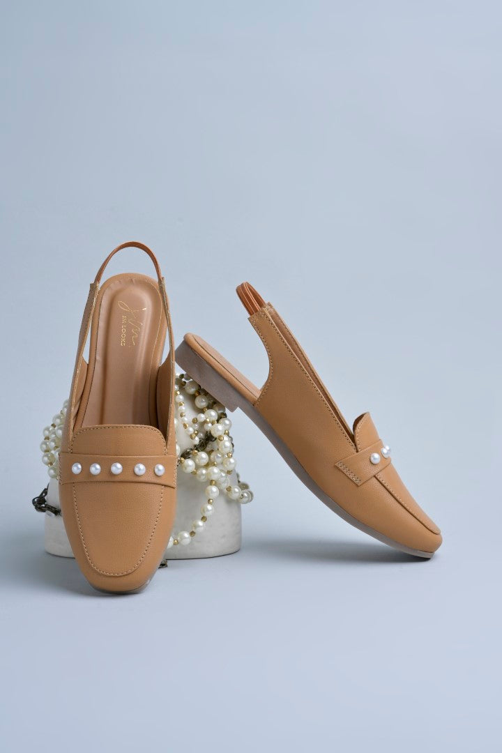 Jm Looks beige slingback loafers adorned with small pearls on the vamp, with a string of pearls in the background
 Beige