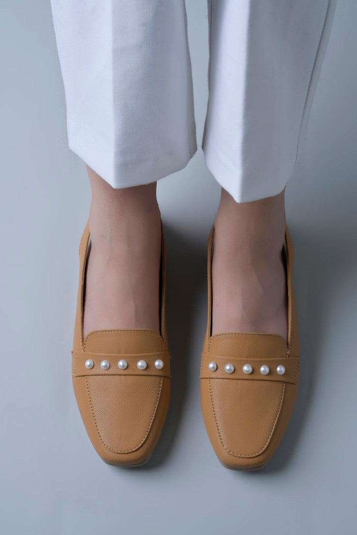 Jm Looks beige slingback loafers adorned with small pearls on the vamp, with a string of pearls in the background
 Beige