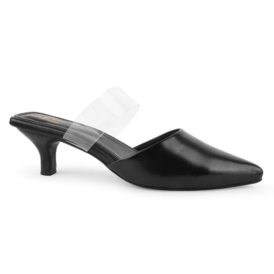 Pointed toe black mules with clear transparent strap and slim curved heel on warm wooden surface