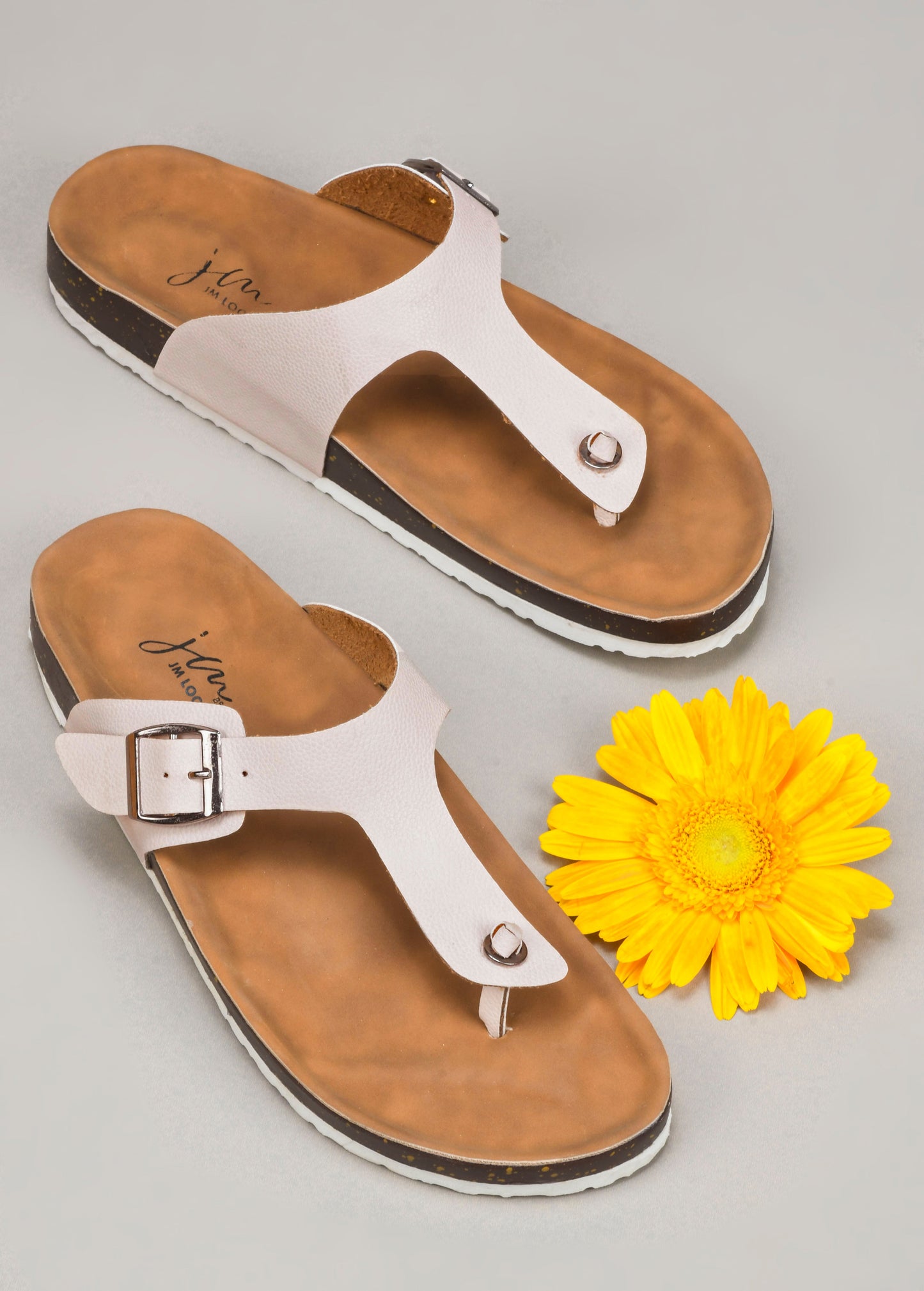 women's thong sandals with an adjustable buckle strap and a contoured footbed
 Cream