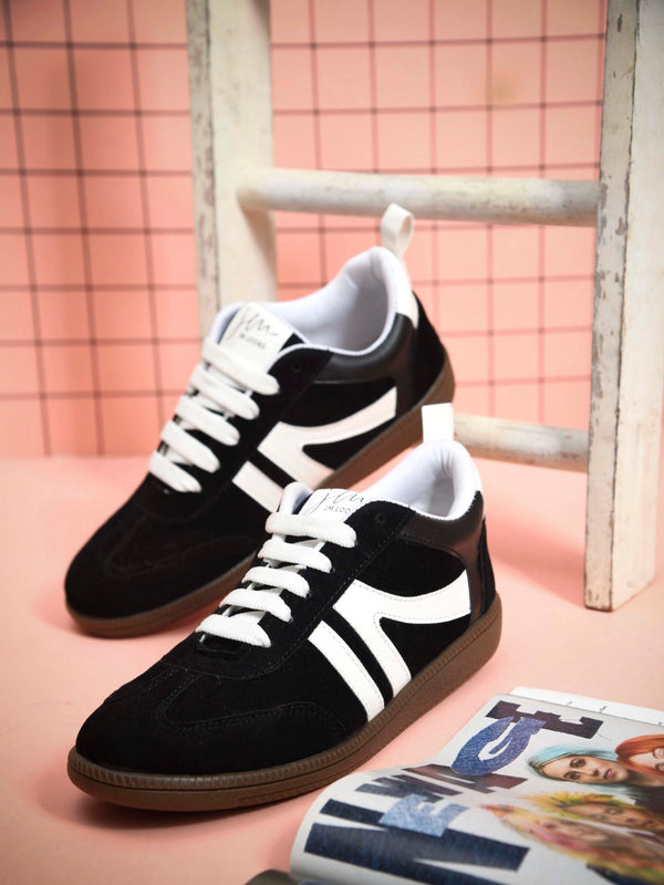 Black casual sneakers for women featuring white side stripes retro low-top design and brown gum sole