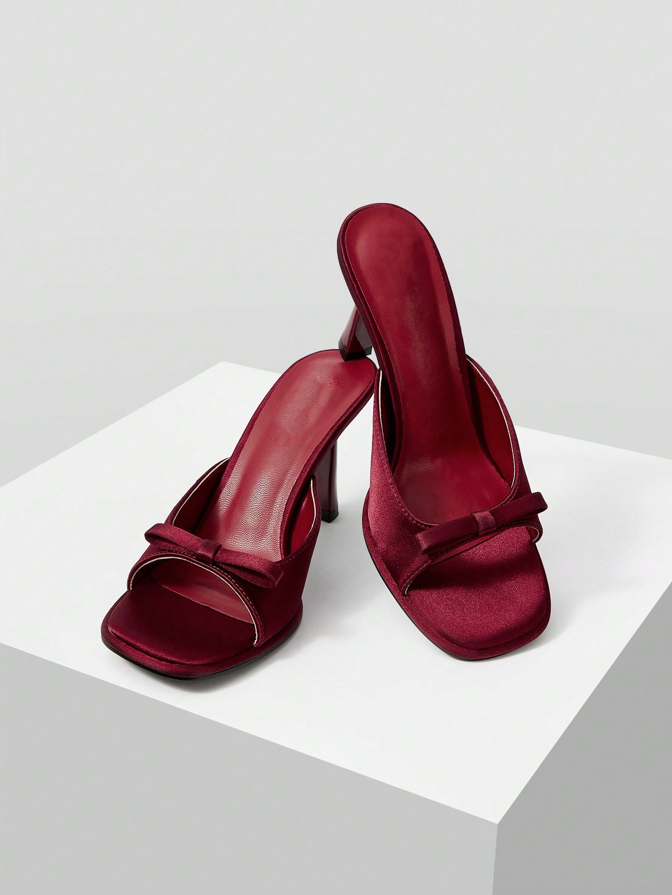 JM Looks heeled mules featuring a small bow detail on the vamp and a sculpted heel Cherry