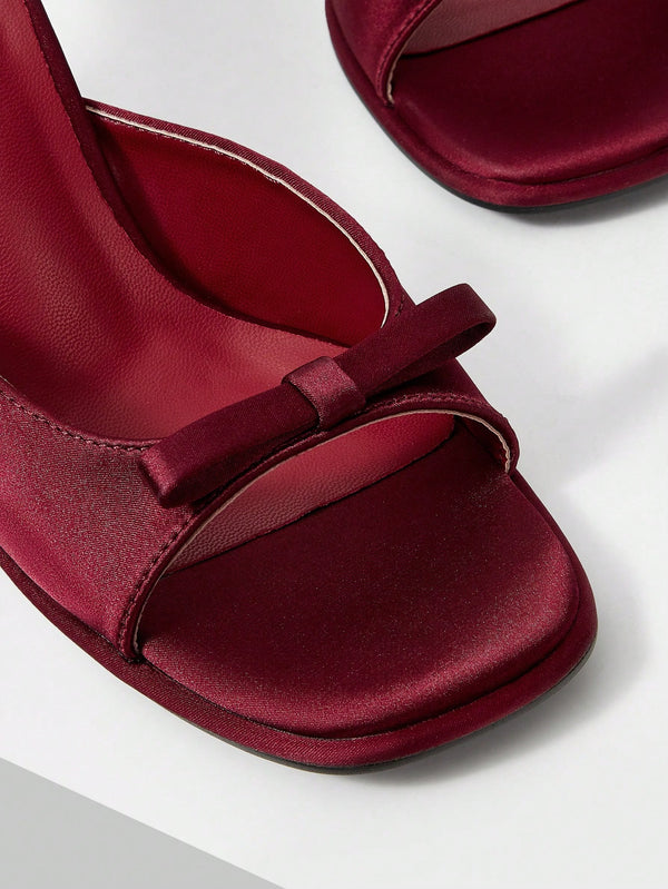 JM Looks heeled mules featuring a small bow detail on the vamp and a sculpted heel Cherry