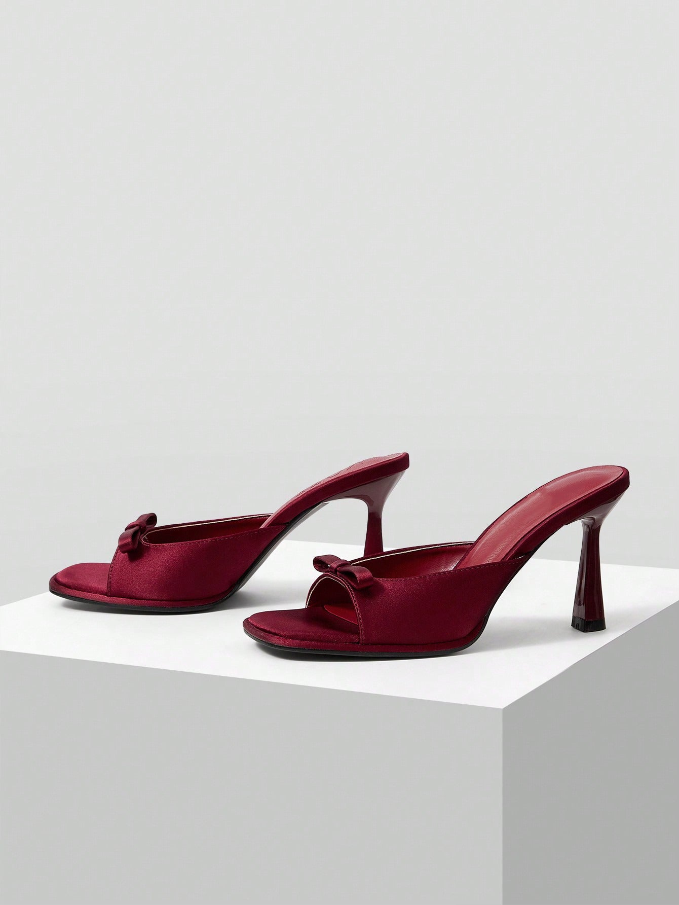 JM Looks heeled mules featuring a small bow detail on the vamp and a sculpted heel Cherry