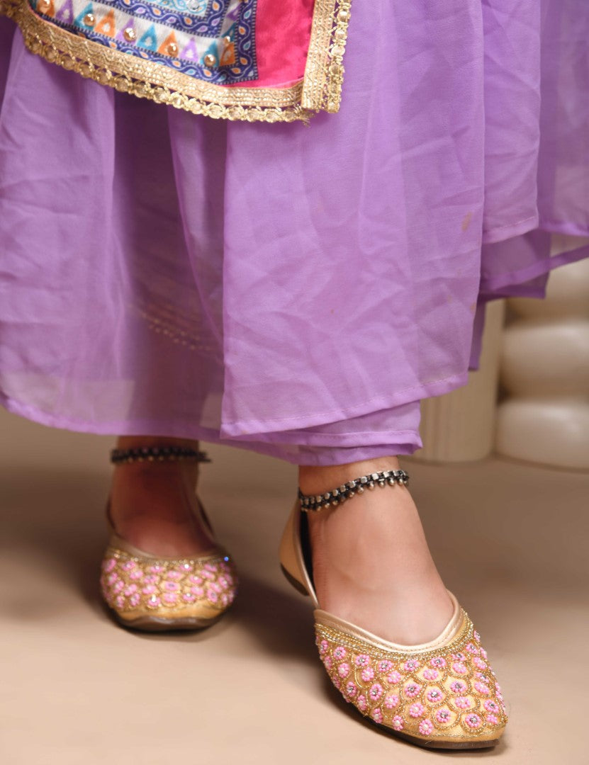 exquisitely embellished juttis featuring a detailed petal design
 Golden
