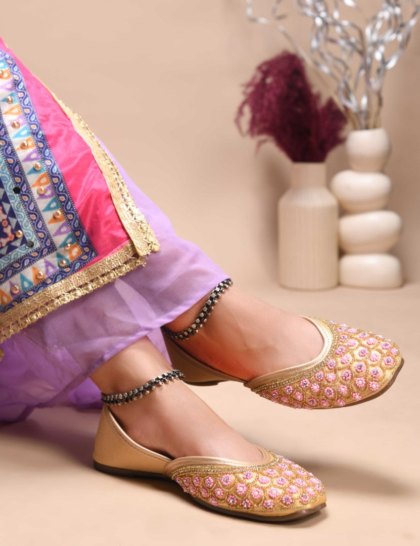 exquisitely embellished juttis featuring a detailed petal design
 Golden