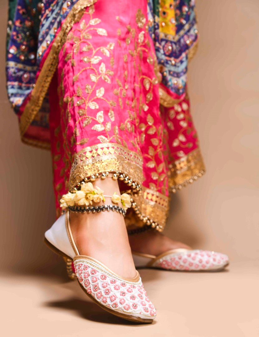 exquisitely embellished juttis featuring a detailed petal design
 White