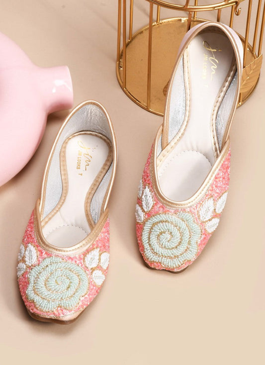 exquisitely beaded juttis featuring a floral design with intricate patterns
 Peach