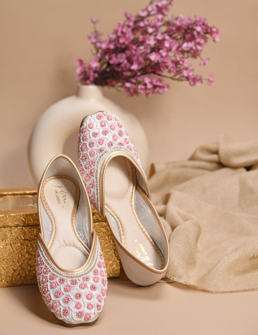 exquisitely embellished juttis featuring a detailed petal design
 White