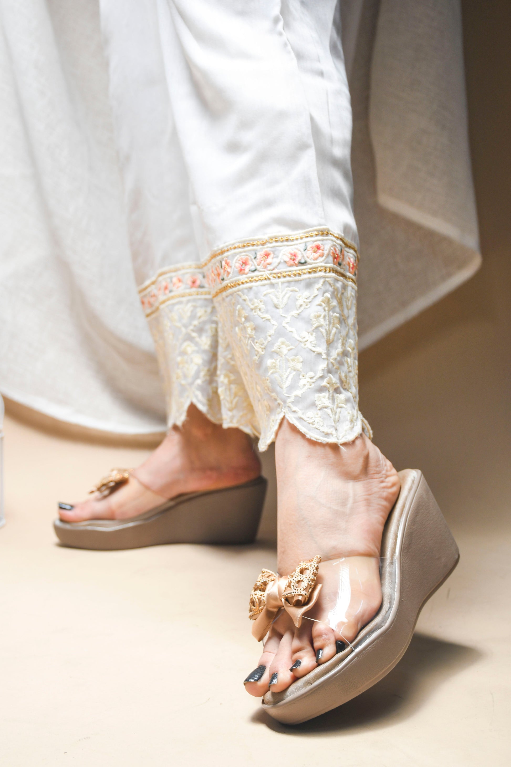 Jm Looks embellished bow wedge platform sandals, with one being worn
 Beige