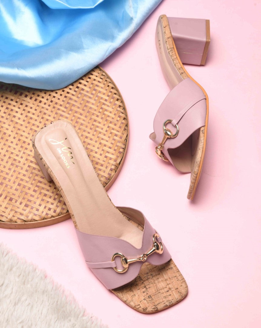 women's mules featuring a wide strap with a buckle embellishment and a cork-textured block heel
 Peach