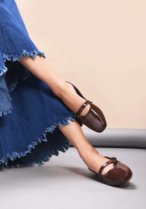 Women's brown patent slip-on mules with bow detail