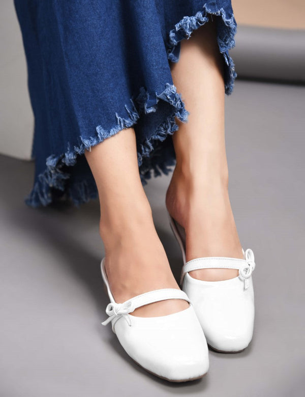 Women's white patent slip-on mules with bow detail