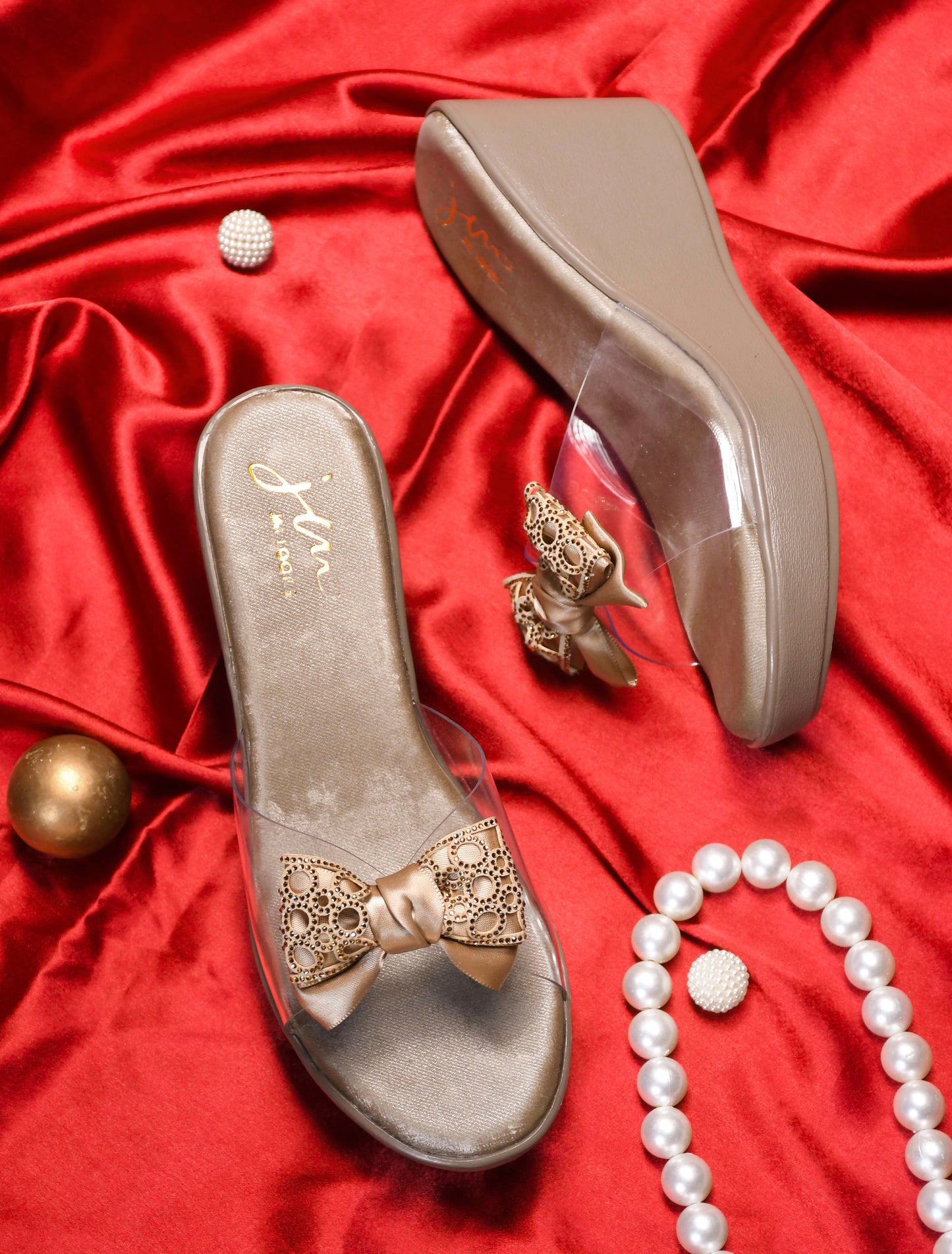 Jm Looks embellished bow wedge platform sandals, with one being worn
 Beige