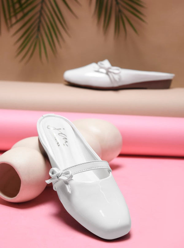 Women's white patent slip-on mules with bow detail