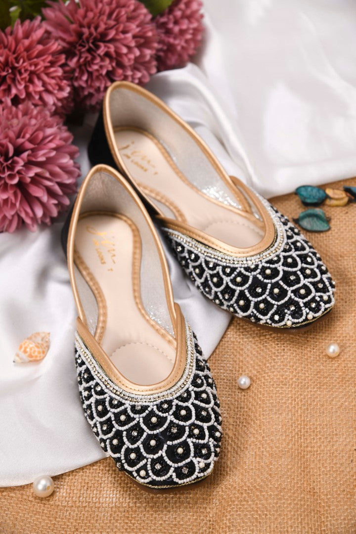 exquisitely embellished juttis featuring a detailed petal design
 Black