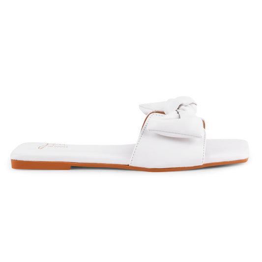 White square-toe flat slides featuring oversized soft knotted bow detail across the front strap, cushioned footbed.