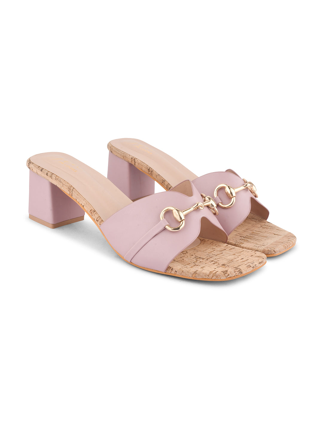 women's mules featuring a wide strap with a buckle embellishment and a cork-textured block heel
 Peach