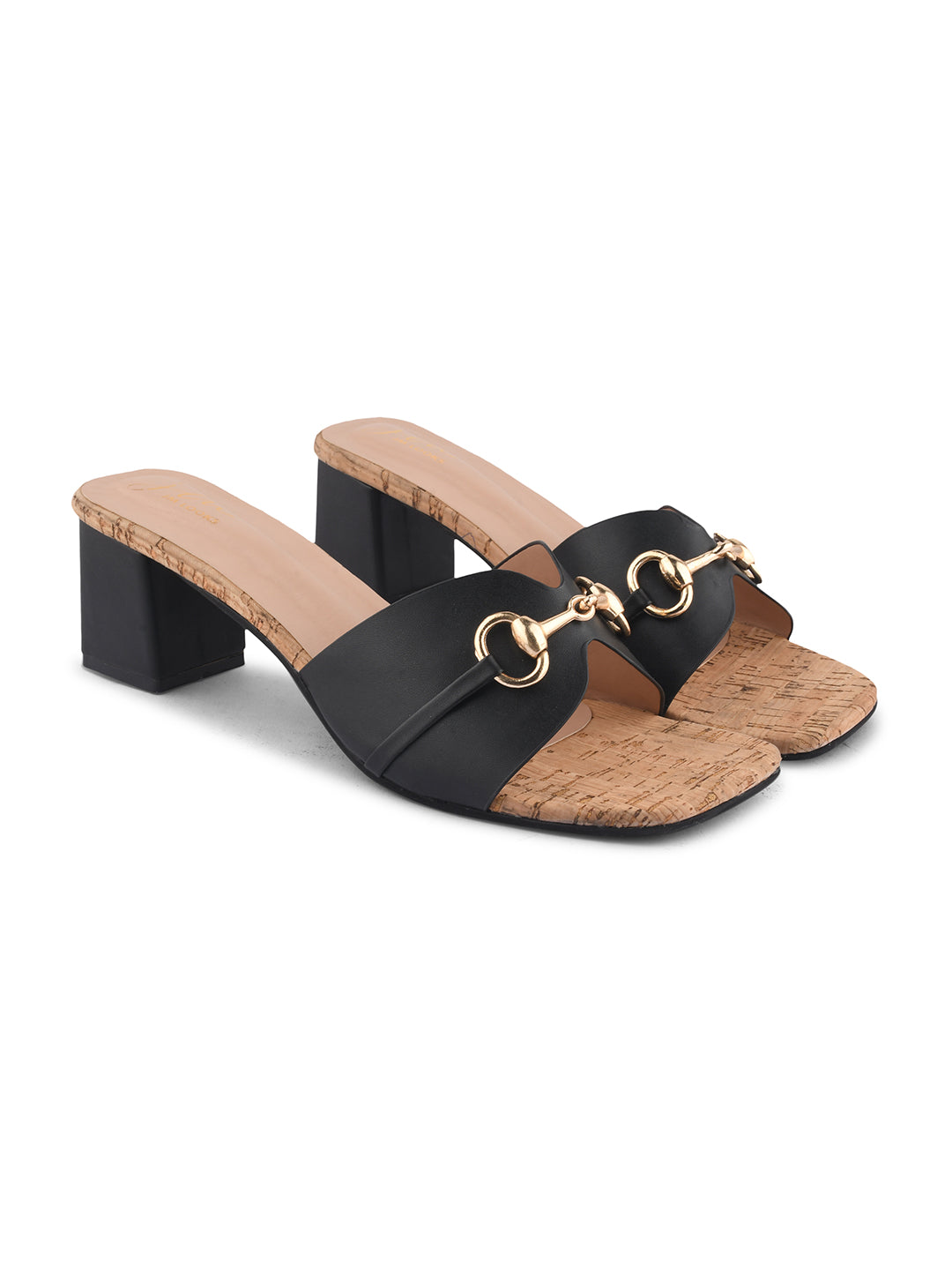women's mules featuring a wide strap with a buckle embellishment and a cork-textured block heel
 Black