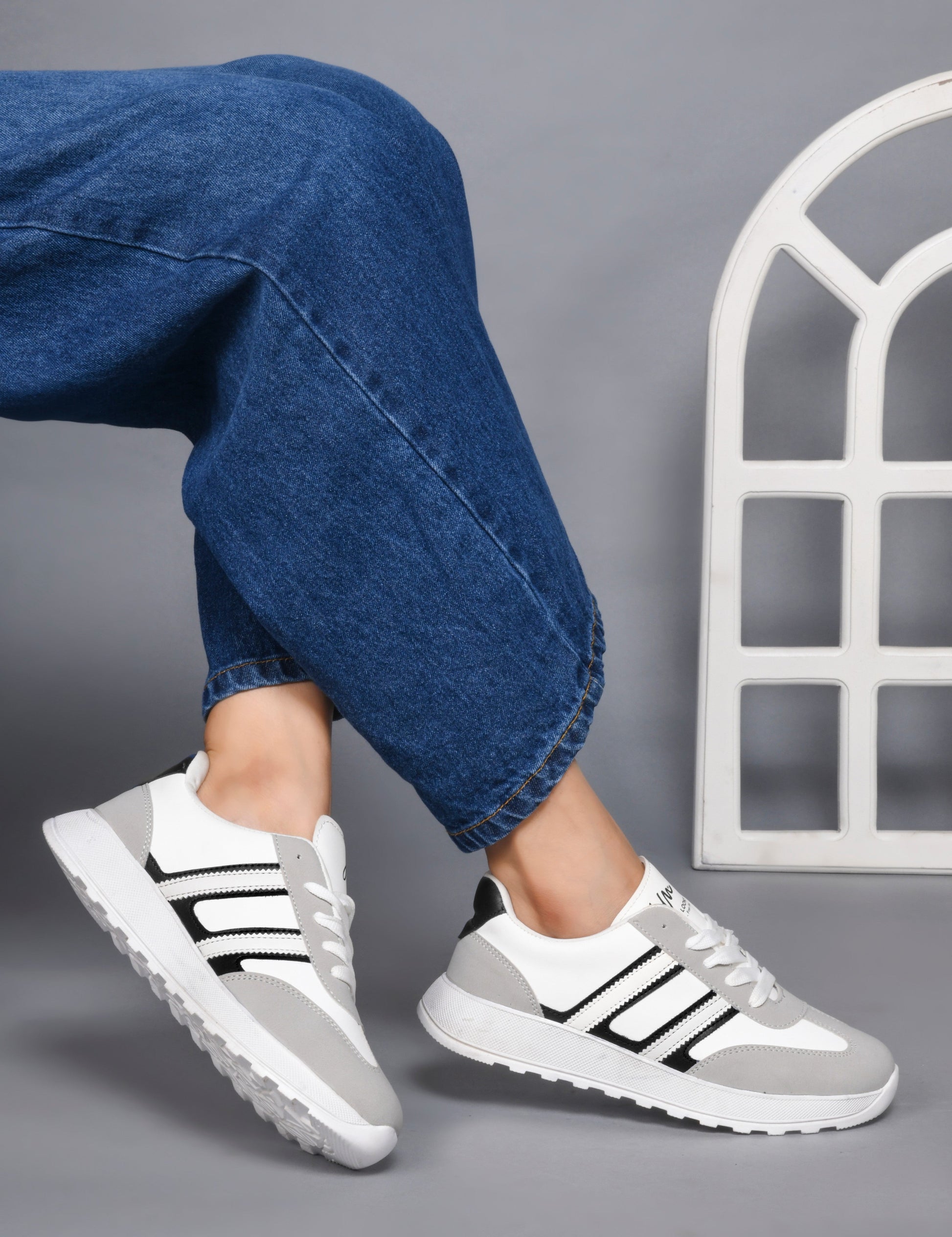 Women's lace-up casual sneakers in grey white with black stripe detailing on cushioned white platform sole