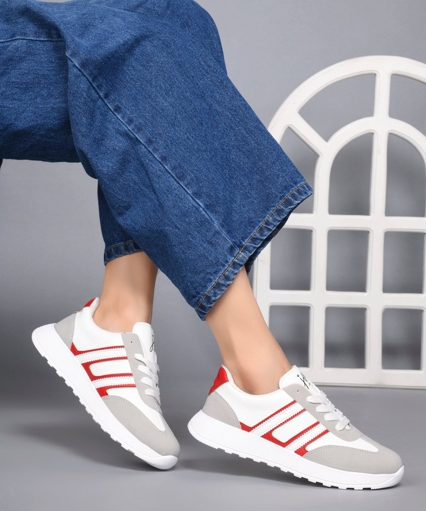 Women's lace-up casual sneakers in grey white with red stripe detailing on cushioned white platform sole
