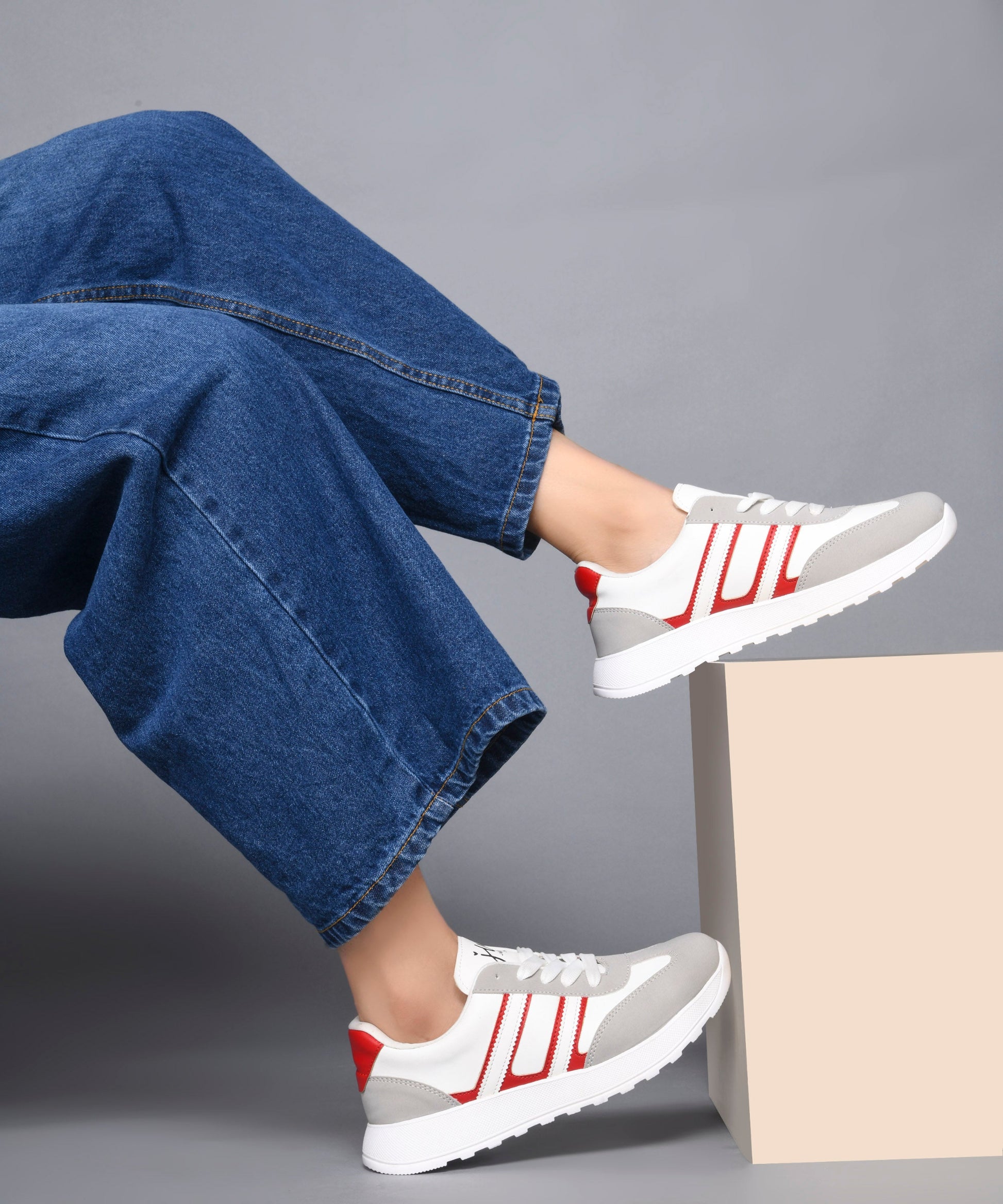Women's lace-up casual sneakers in grey white with red stripe detailing on cushioned white platform sole