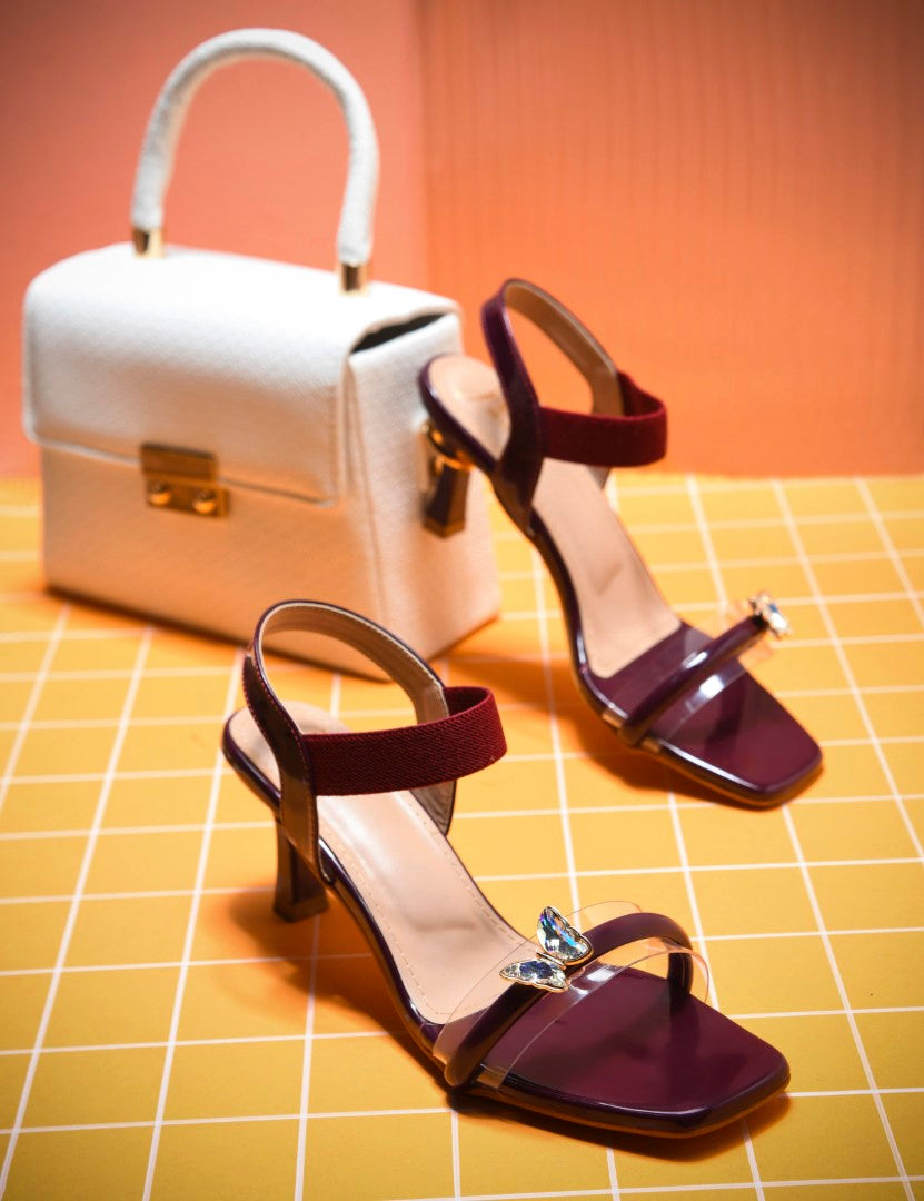 heel sandals with a butterfly embellishment on the clear front strap
 Cherry