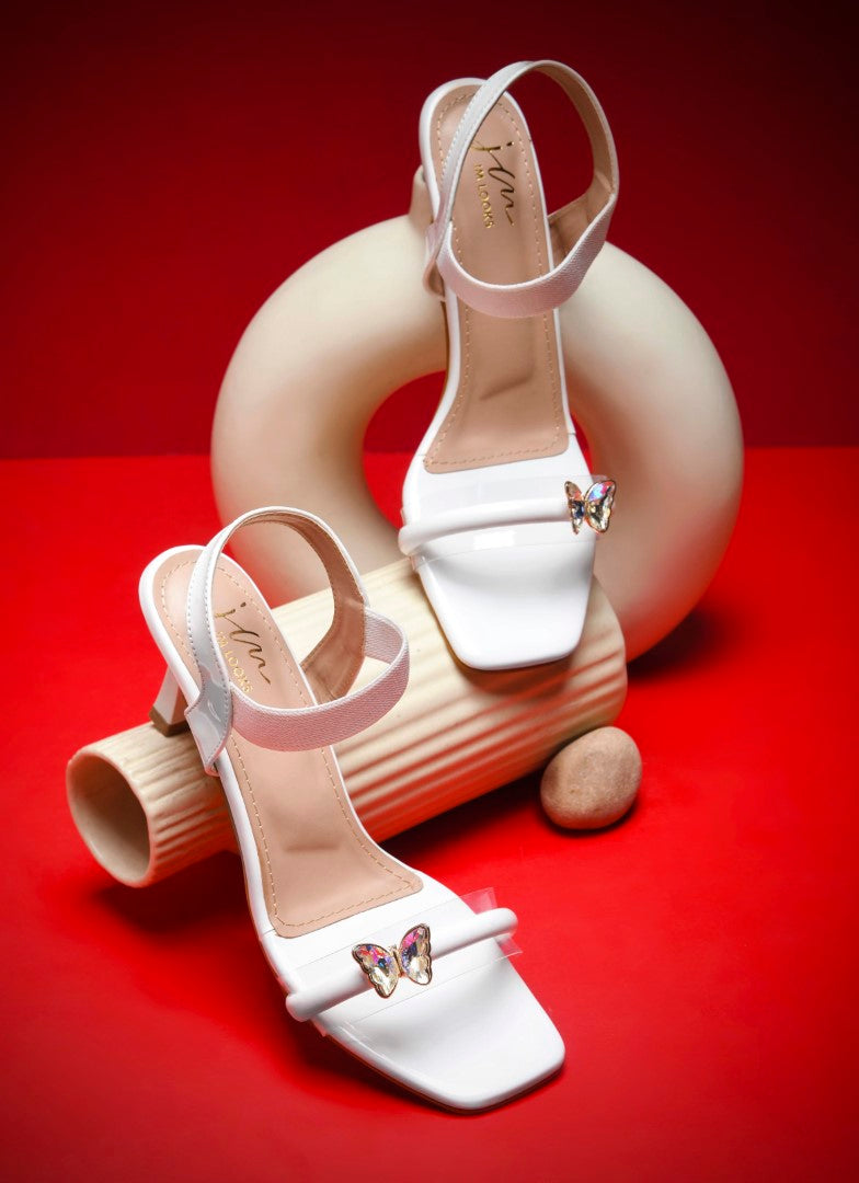 heel sandals with a butterfly embellishment on the clear front strap
 White