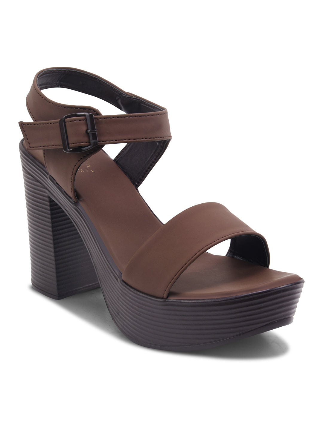 Woman wearing brown chunky platform block heels with open toe and ankle buckle strap, styled with skirt