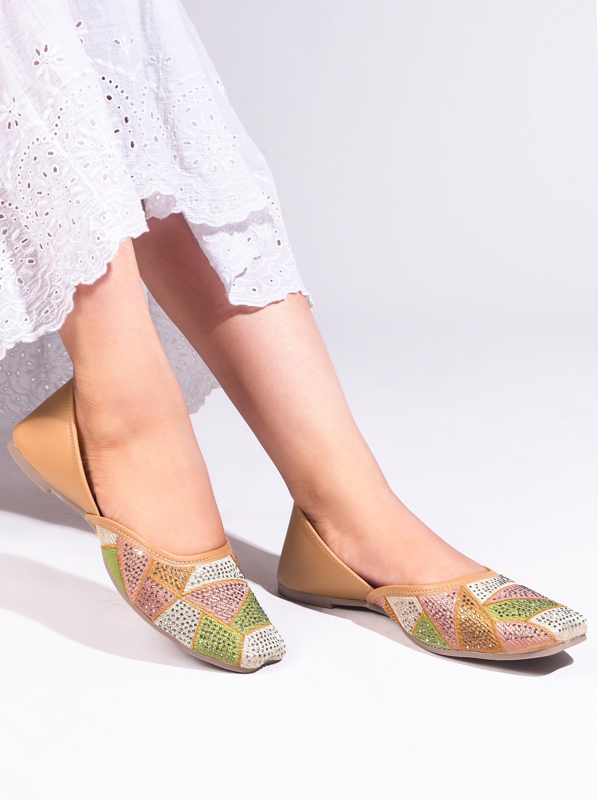 embellished juttis featuring a vibrant geometric pattern with sparkling details
 Beige