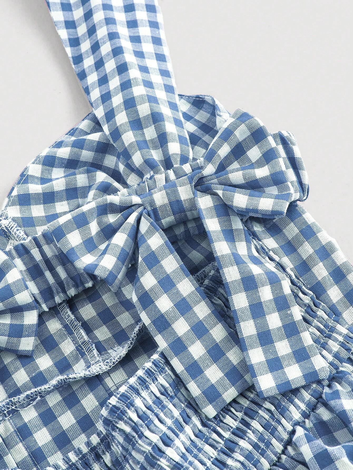 Blue gingham checked sleeveless dress with sweetheart neckline, wide straps, bow detail, and flared A-line silhouette