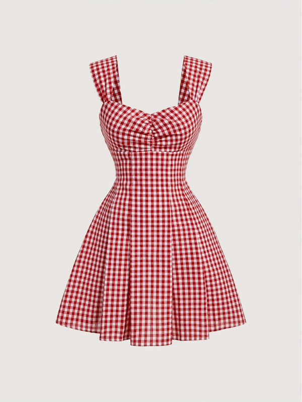 Red gingham sleeveless mini dress with bow detail, sweetheart neckline, wide straps, and flared A-line skirt
