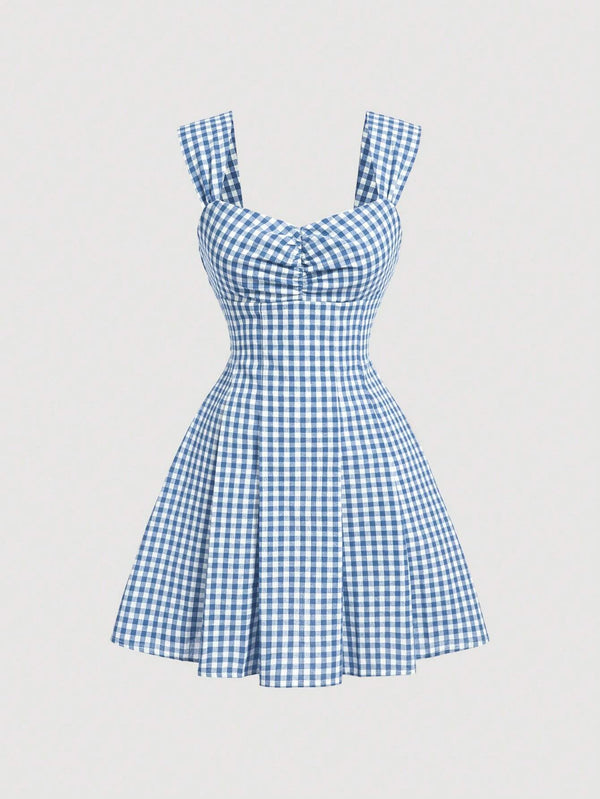 Blue gingham sleeveless mini dress with bow detail, sweetheart neckline, wide straps, and flared A-line skirt