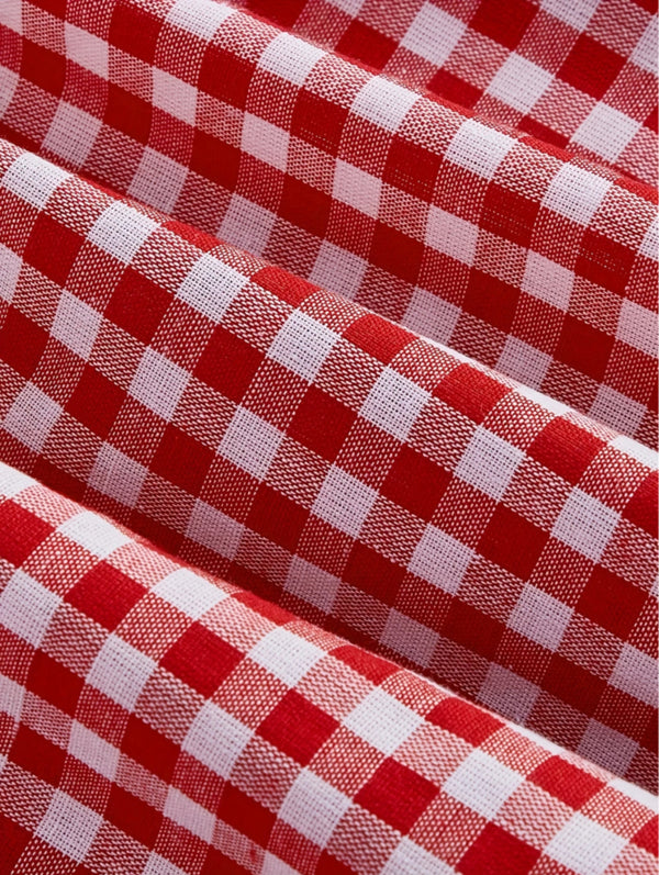 Red gingham sleeveless mini dress with bow detail, sweetheart neckline, wide straps, and flared A-line skirt