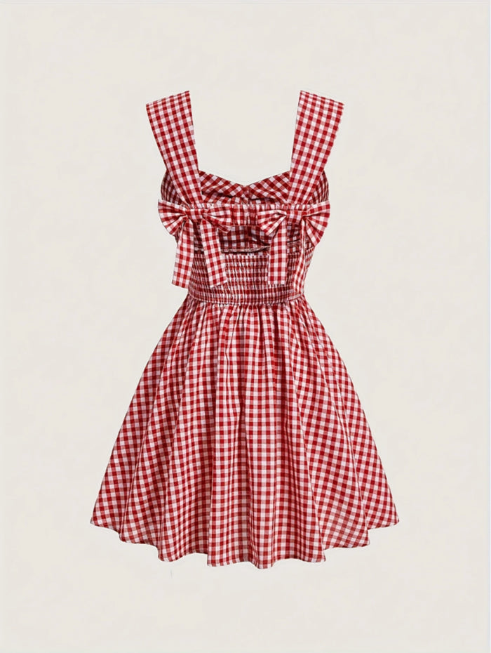 Red gingham sleeveless mini dress with bow detail, sweetheart neckline, wide straps, and flared A-line skirt