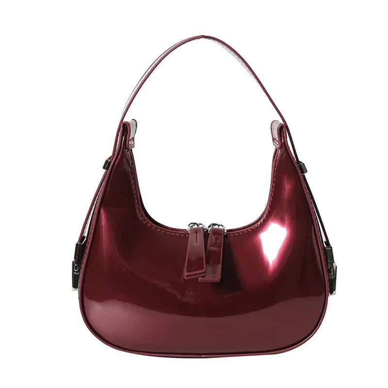 Wine-Red half moon handbag for women in glossy patent finish with curved crescent shape and dual zip pulls.