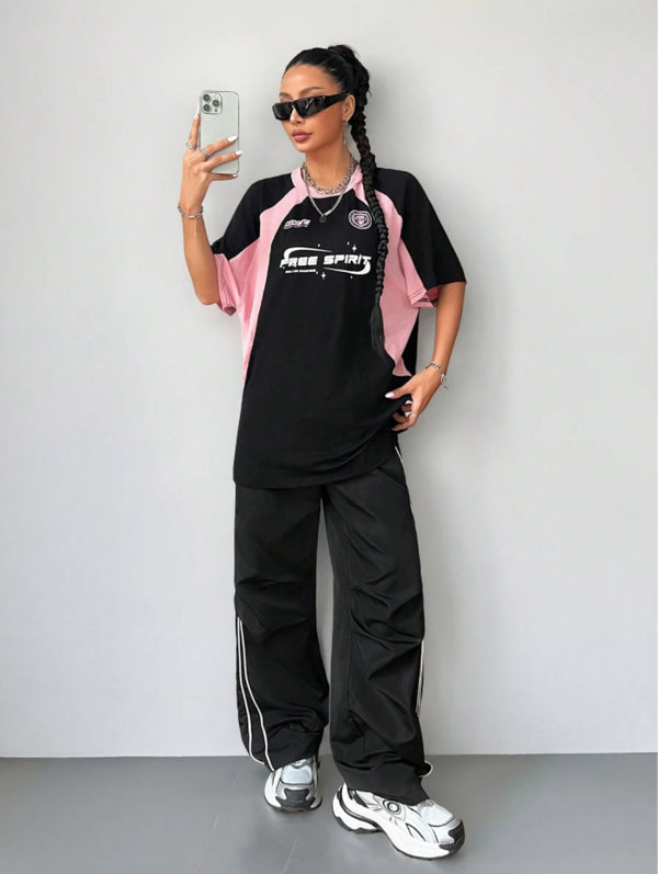 Oversized streetwear graphic t-shirt in black with pink side panels and bold typography front back design