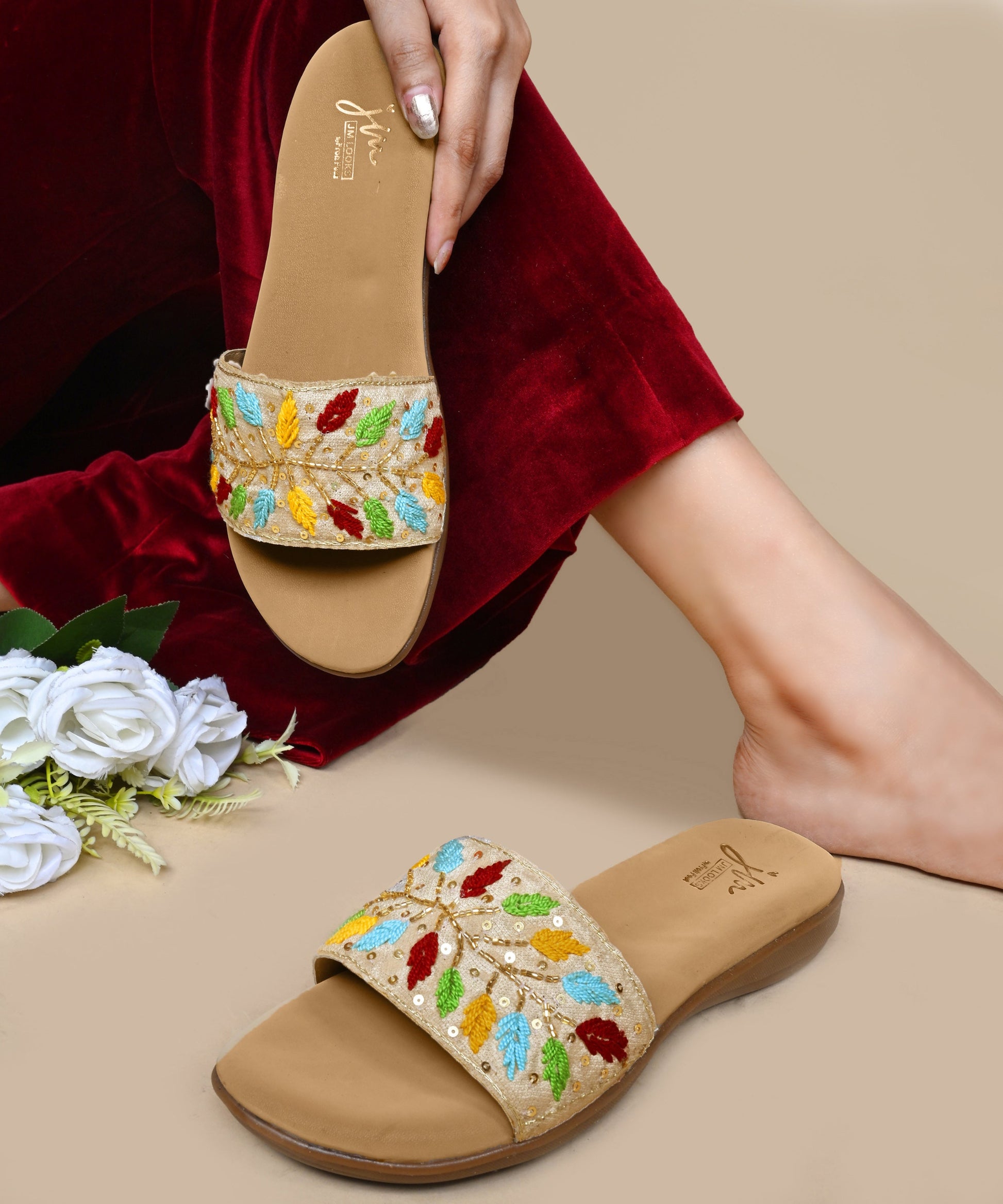 Sandals for women featuring beige embroidered leaf strap with sequins, cushioned footbed, and casual slip-on design.