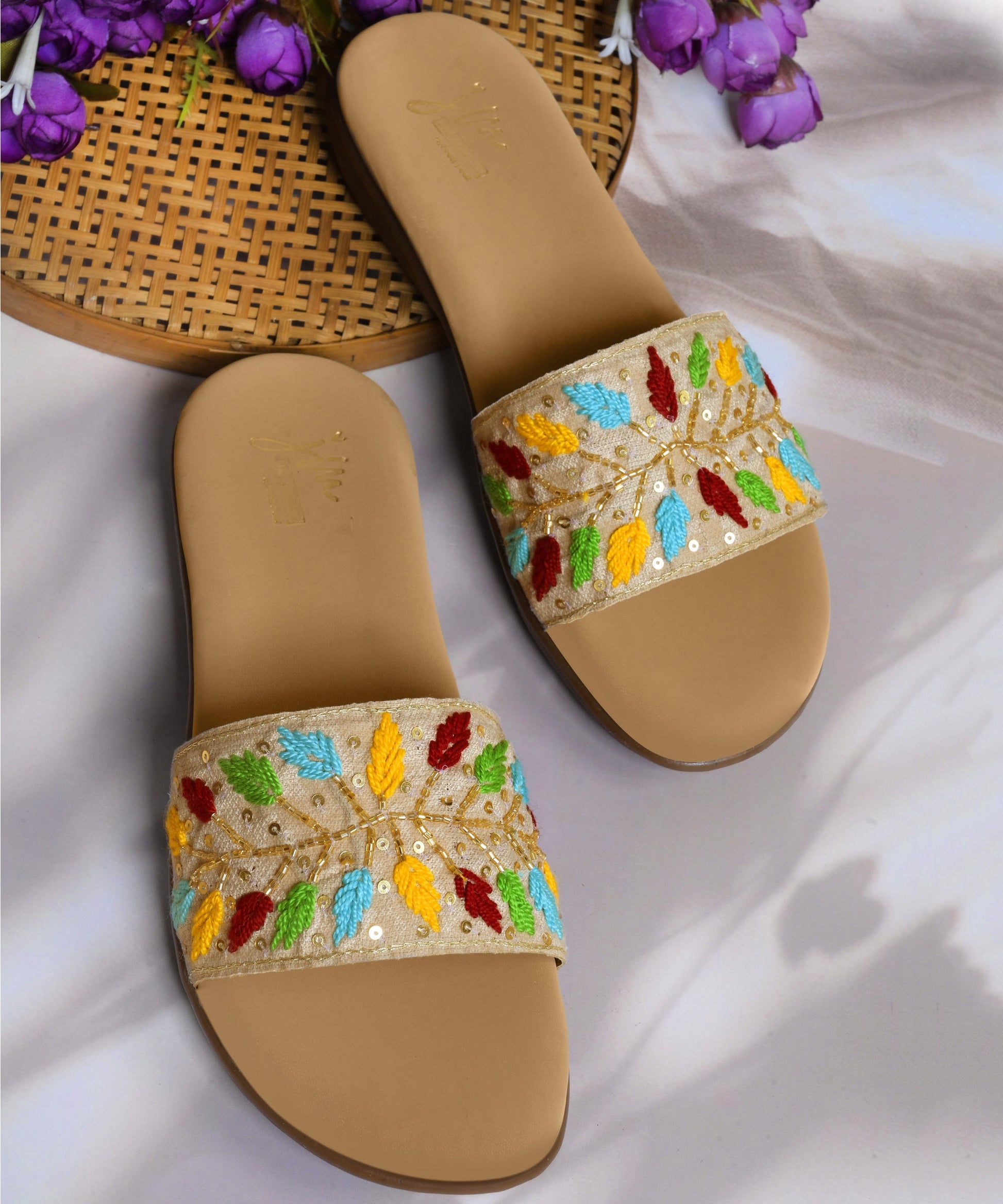 Sandals for women featuring beige embroidered leaf strap with sequins, cushioned footbed, and casual slip-on design.
