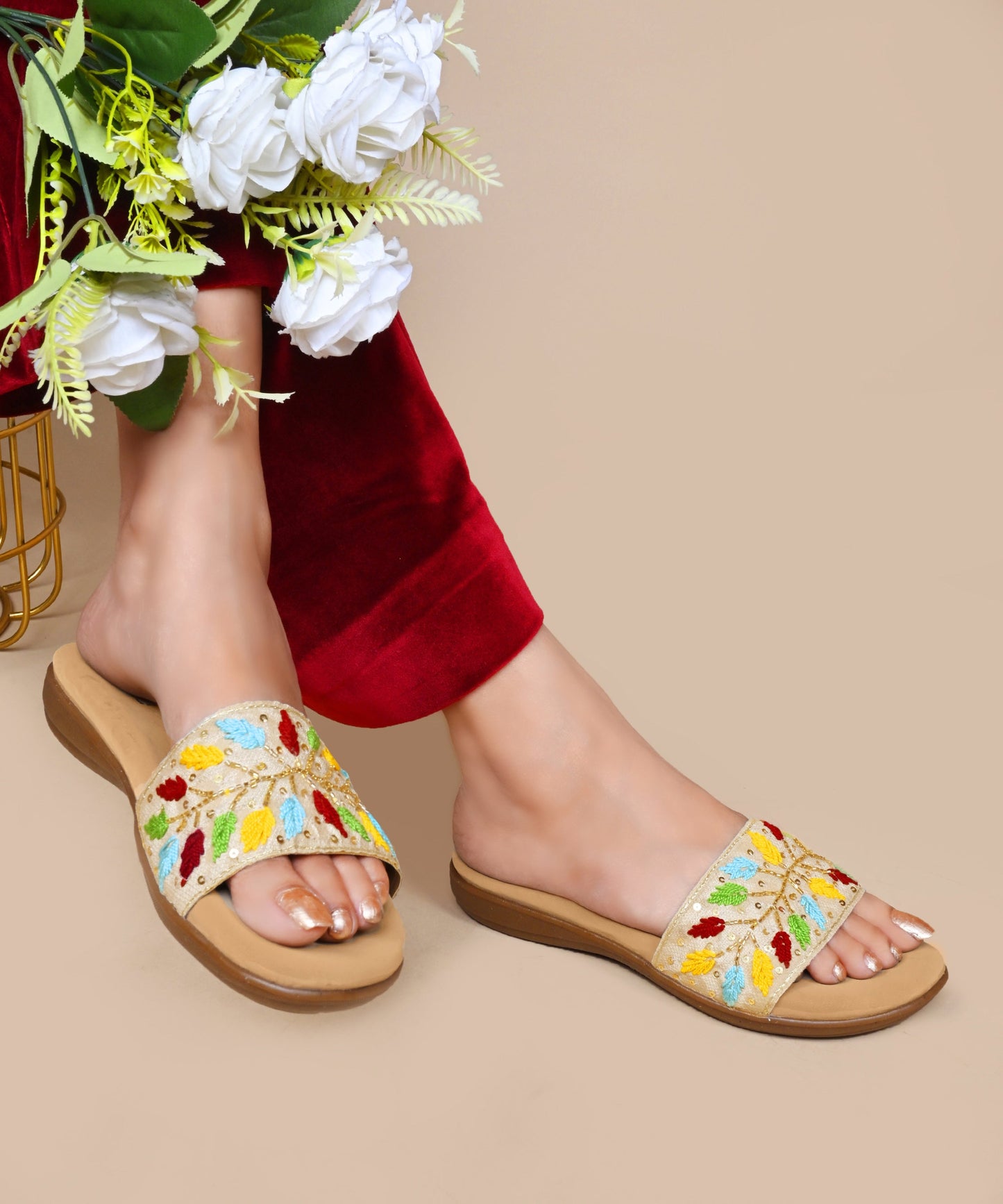 Sandals for women featuring beige embroidered leaf strap with sequins, cushioned footbed, and casual slip-on design.
