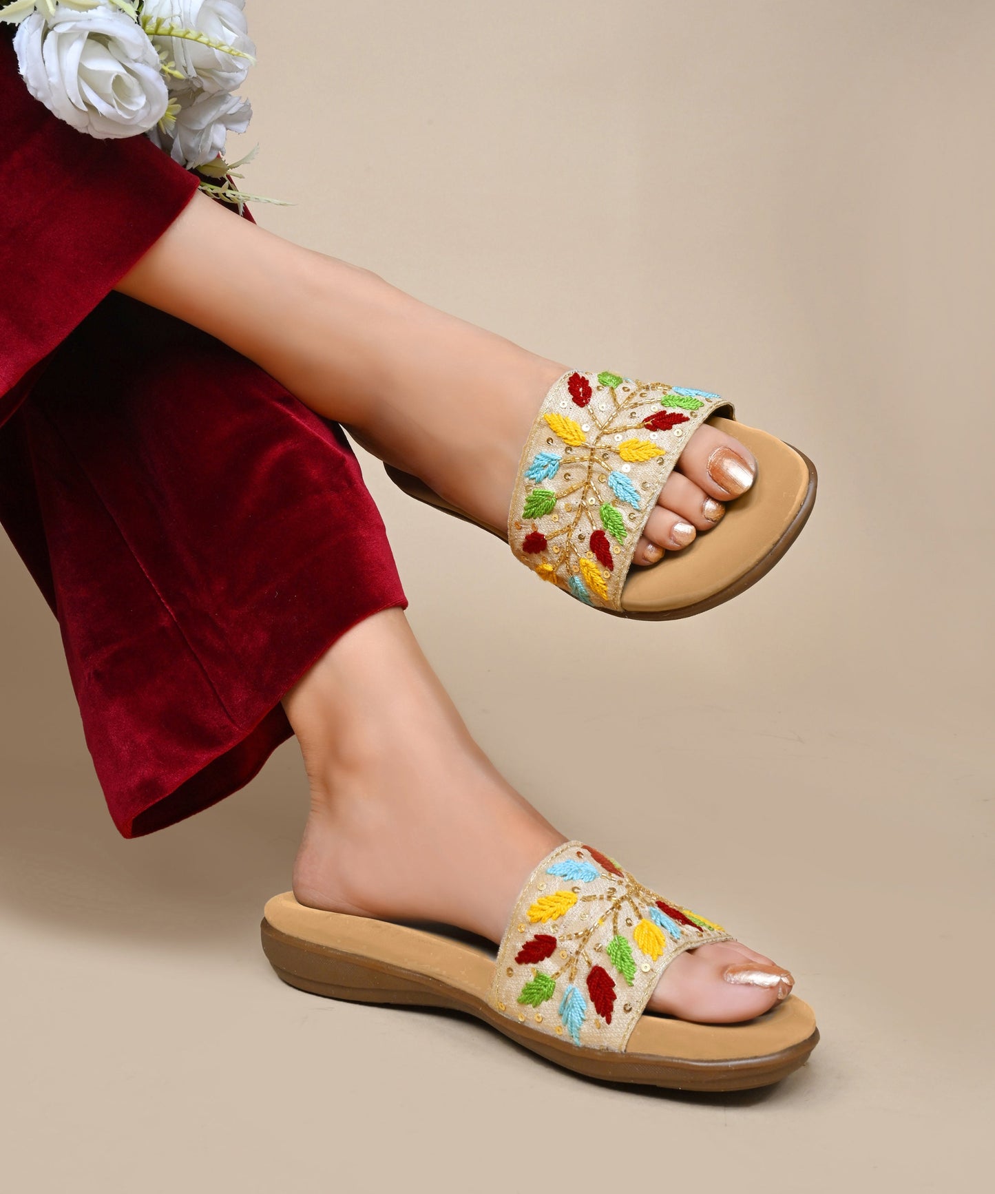 Sandals for women featuring beige embroidered leaf strap with sequins, cushioned footbed, and casual slip-on design.