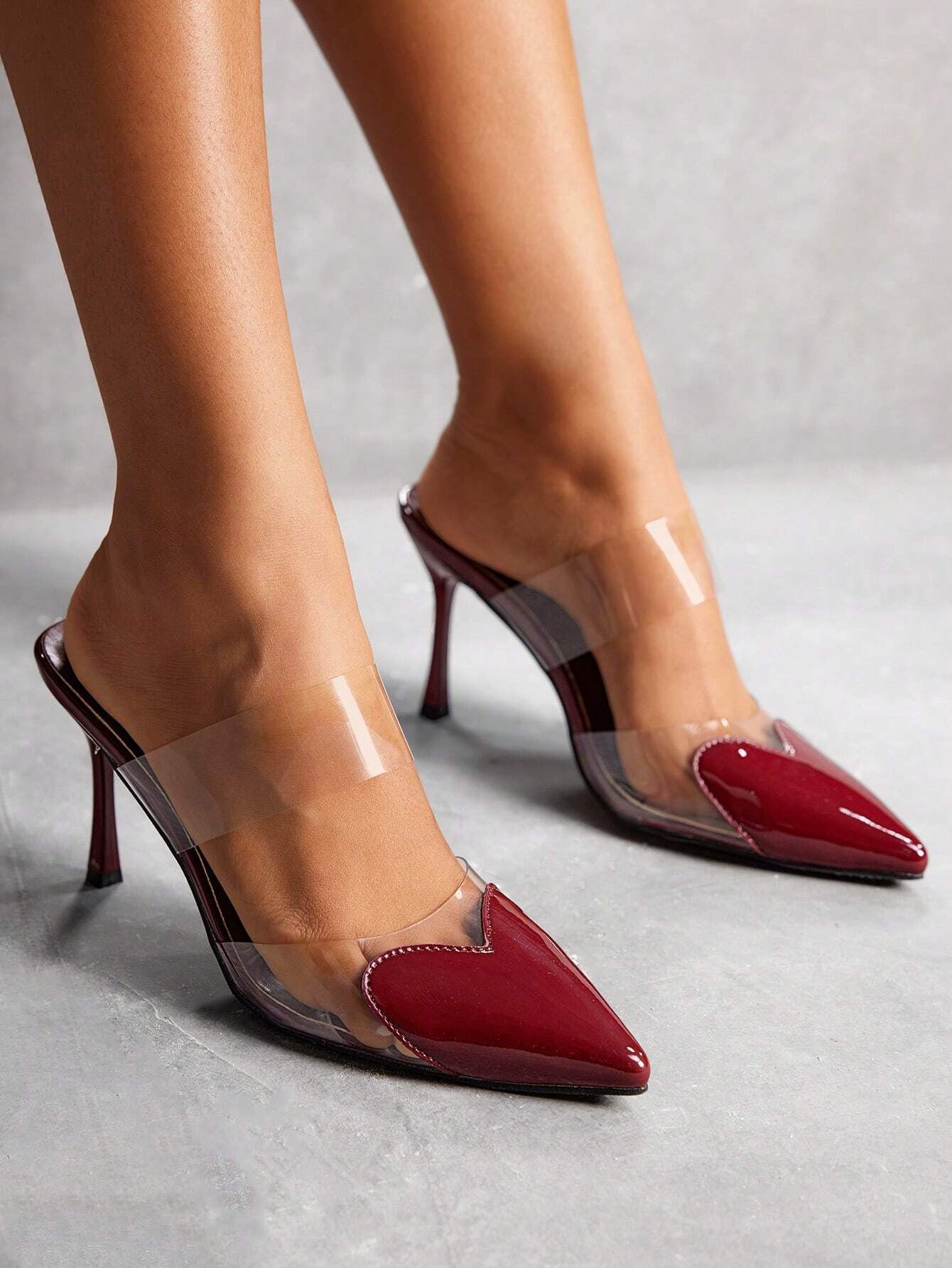 Transparent strap pointed toe mules in cherry red patent featuring slim stiletto heels for stylish women